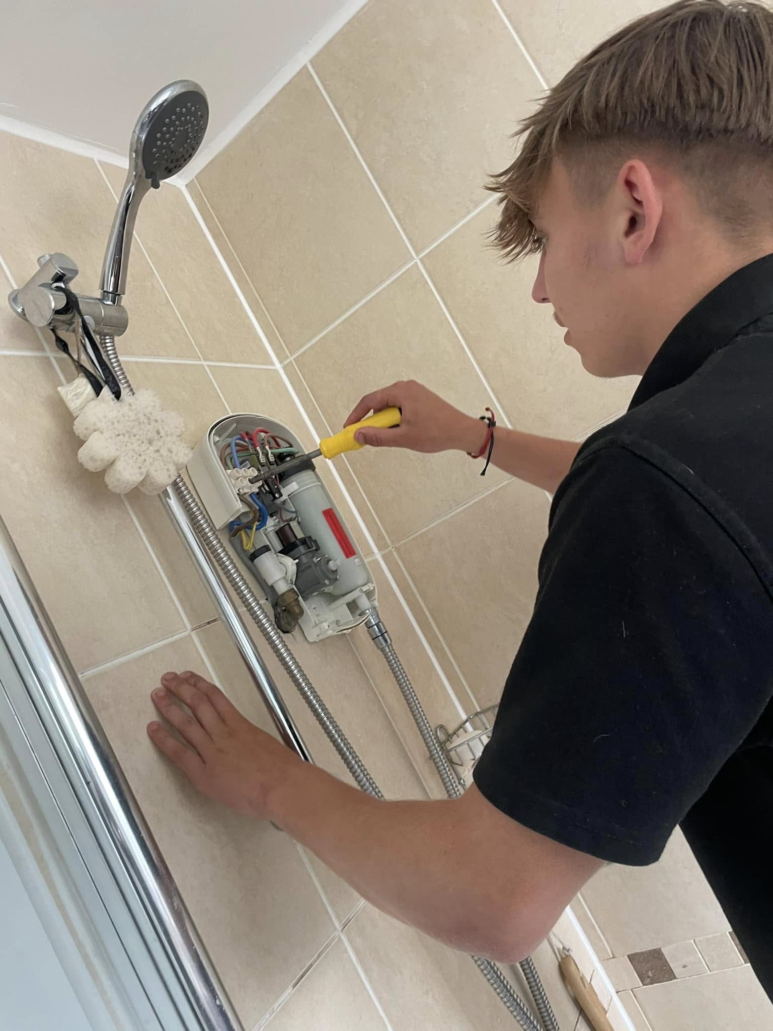 CGH engineer doing repair work for a shower