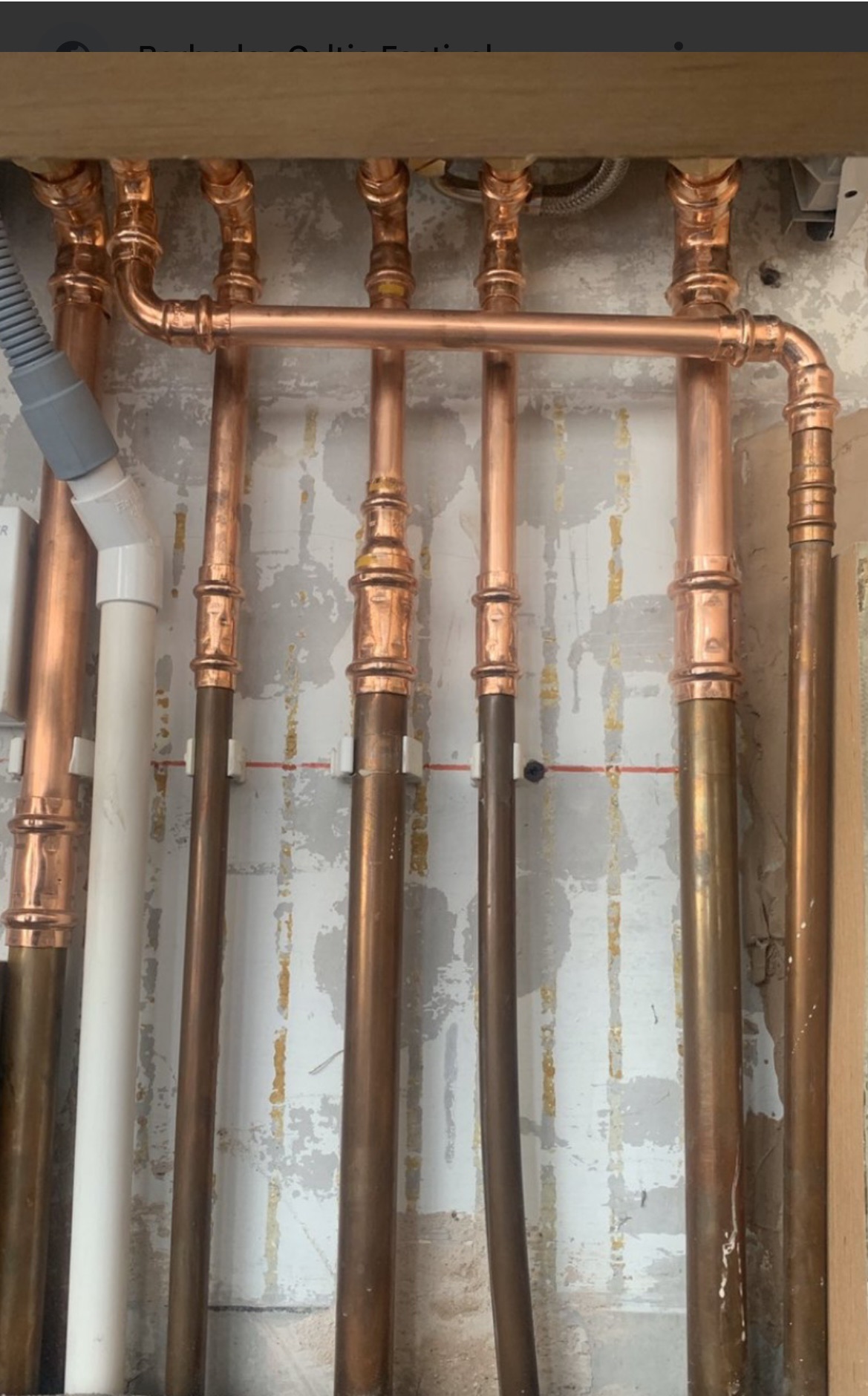 Newly fitted cooper pipes during a plumbing service of a house